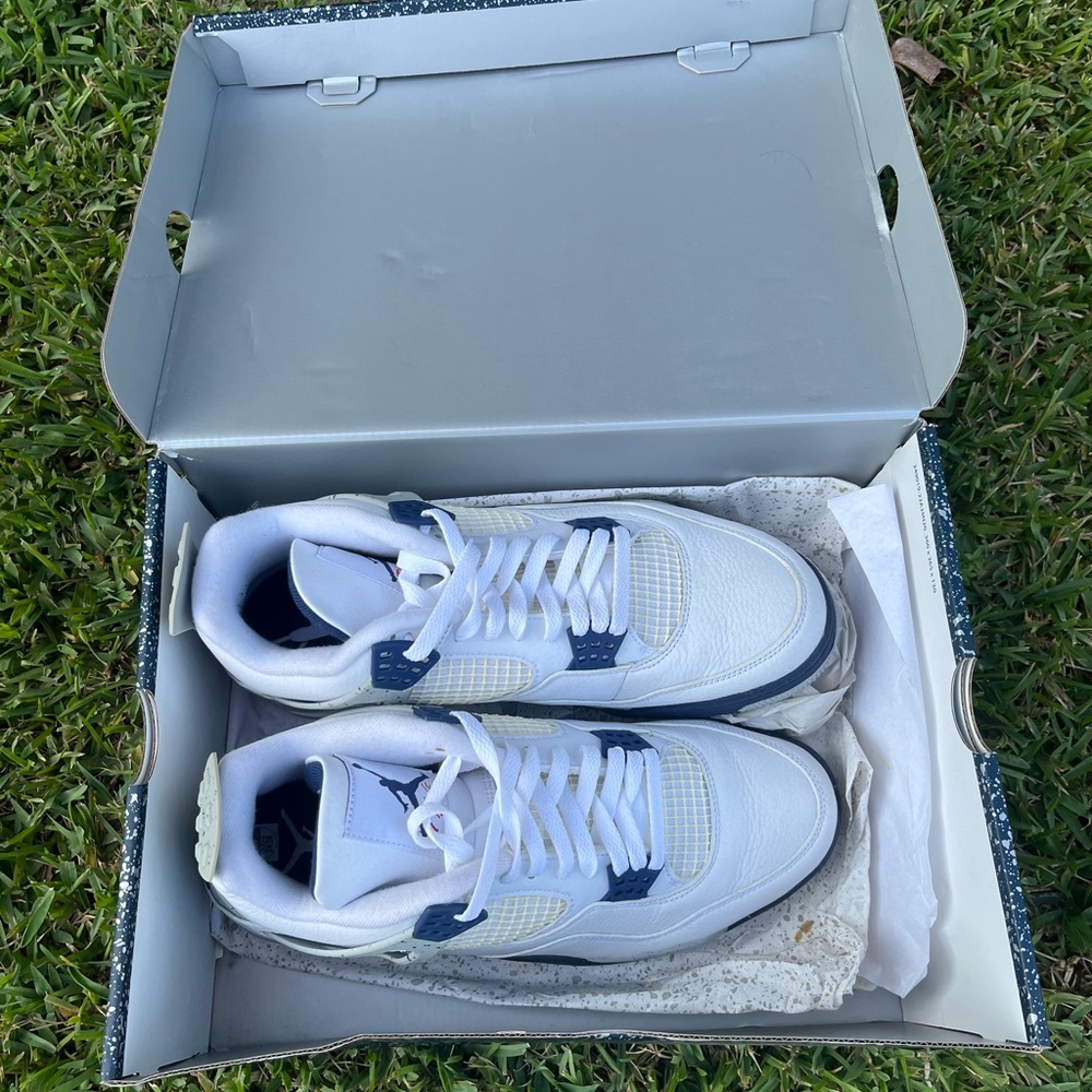 White and navy retro Jordan 4s.